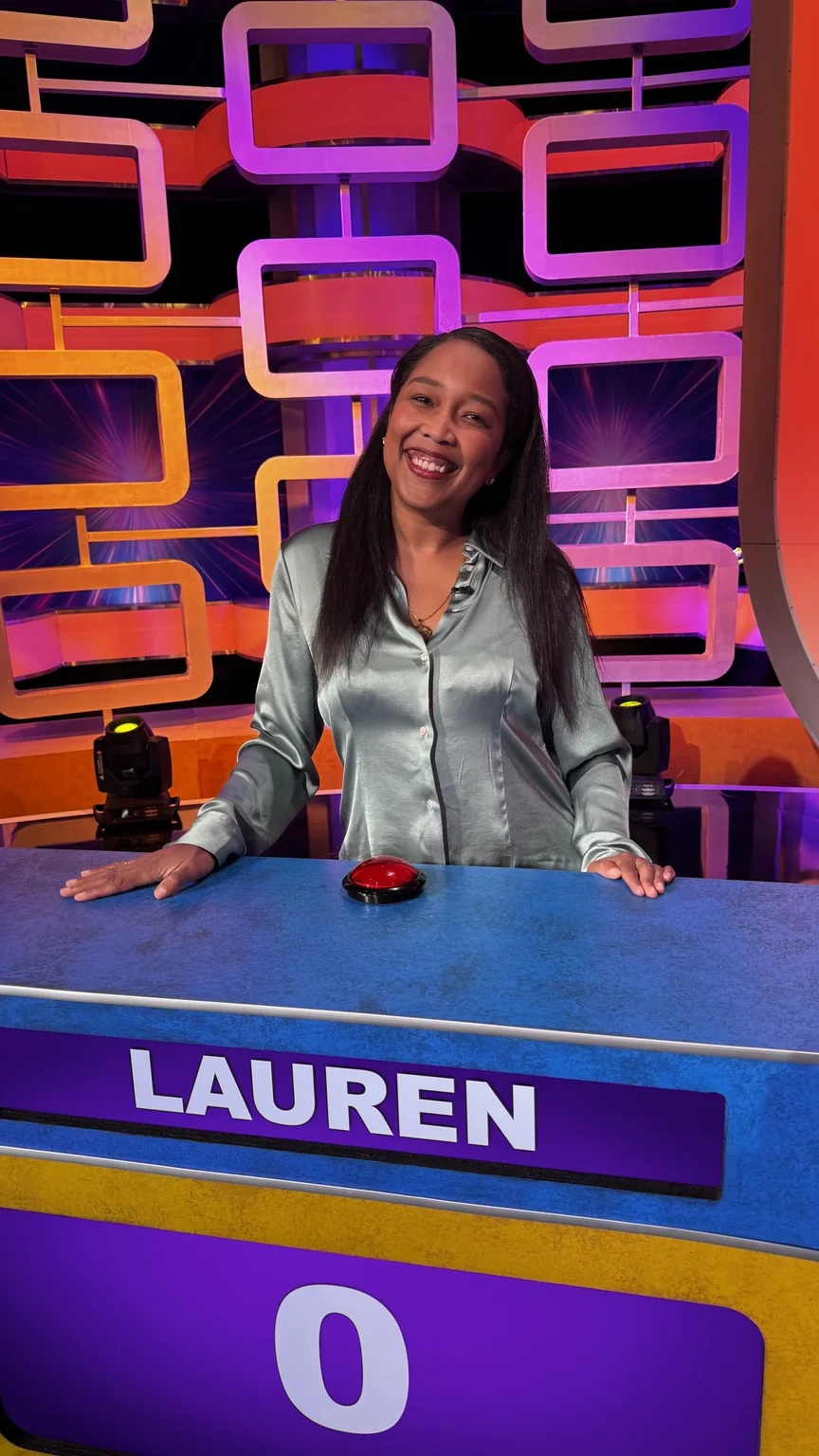Lauren Bush at the Scrambled Up game-show podium on the television set.
